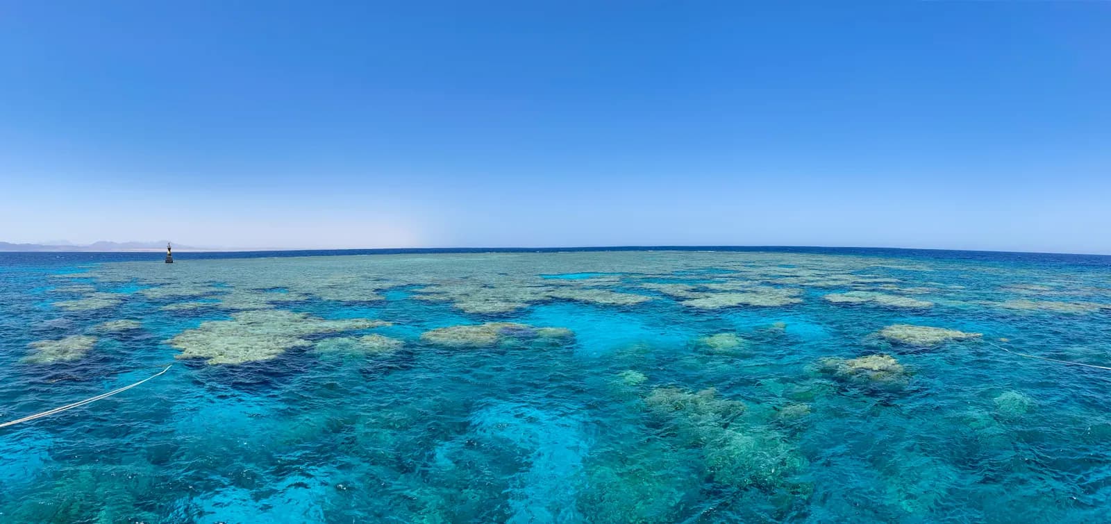 Shallow turquoise coral reef flat of the kind snorkelled at Sataya, Egyptian Red Sea